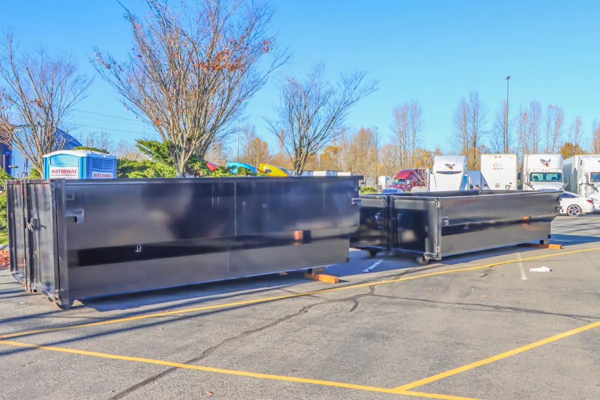 Professional dumpster rental service with roll-off container on residential driveway in Belvidere